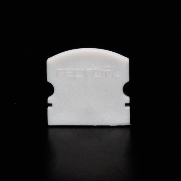 Weiße Plastikkappe mit der Aufschrift 'raptore' auf schwarzem Hintergrund.