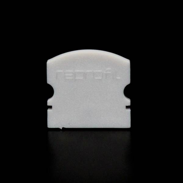 Ein weißes, halbkreisförmiges Plastikobjekt auf schwarzem Hintergrund. Das Objekt hat zwei kleine, symmetrische Einschnitte und ist mit 'rebnoft' beschriftet.