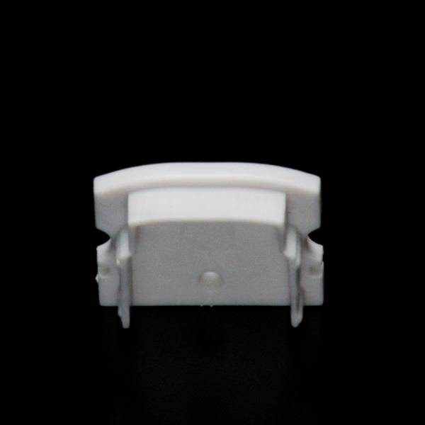 Ein weißer, rechteckiger Kunststoffclip vor einem schwarzen Hintergrund. Der Clip hat abgerundete Kanten und seitliche Halterungen.