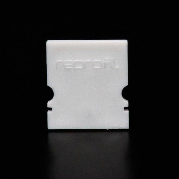 Weiße, rechteckige Kunststoffhalterung auf schwarzem Hintergrund. Erhabenes Logo 'reprofil' auf der Vorderseite zu sehen.