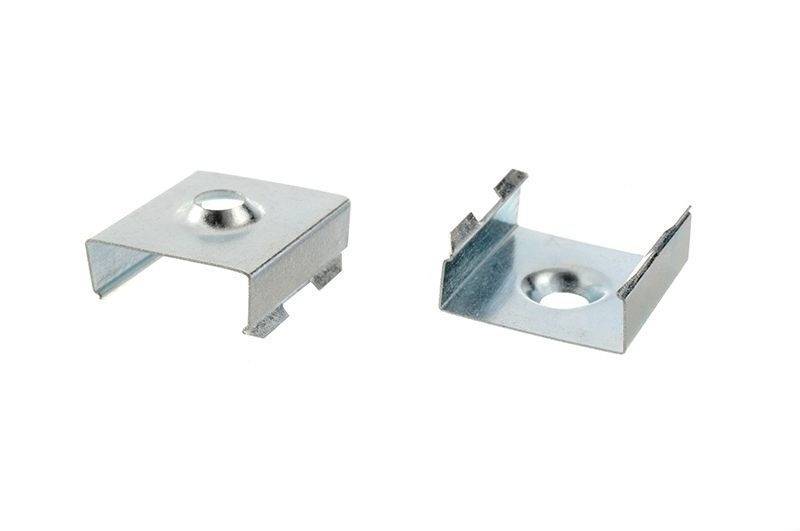 Metallklammern mit mittigem Loch, links geschlossen, rechts geöffnet, zur Befestigung oder Verbindung von Bauteilen.