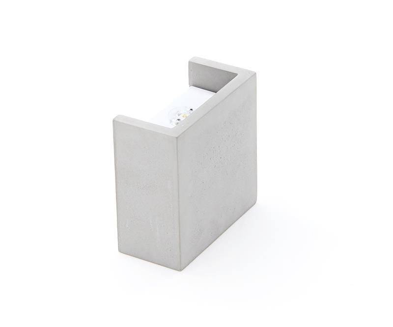 Grauer Klebeband-Abroller aus Beton mit minimalistischem Design, freistehend vor weißem Hintergrund.