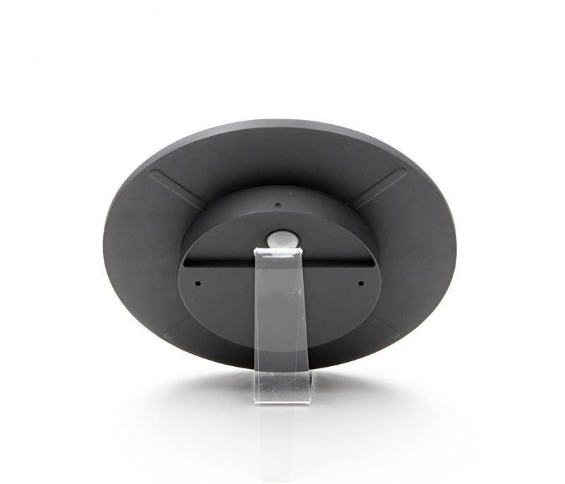 Ein schwarzer runder digitaler Bilderrahmen auf einem transparenten Ständer, von hinten gezeigt.