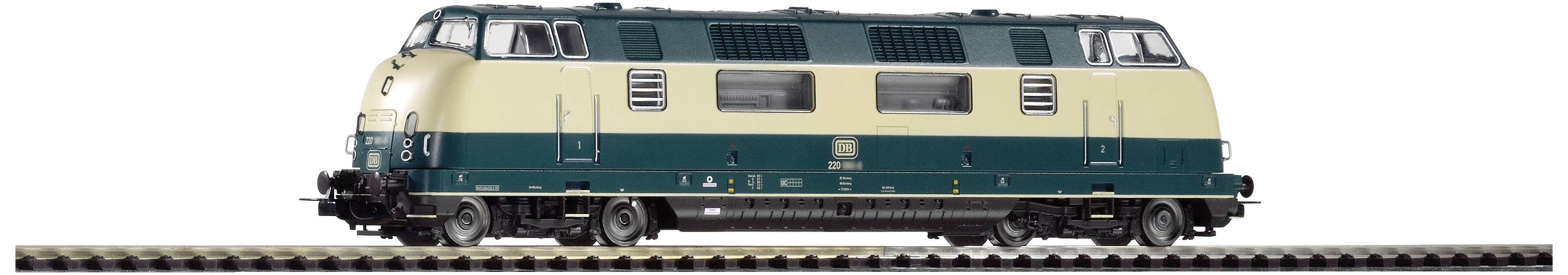 Modell einer zweifarbigen Modelleisenbahn-Lokomotive auf Schienen. Sie ist beige und dunkelgrün mit detaillierter Oberfläche.