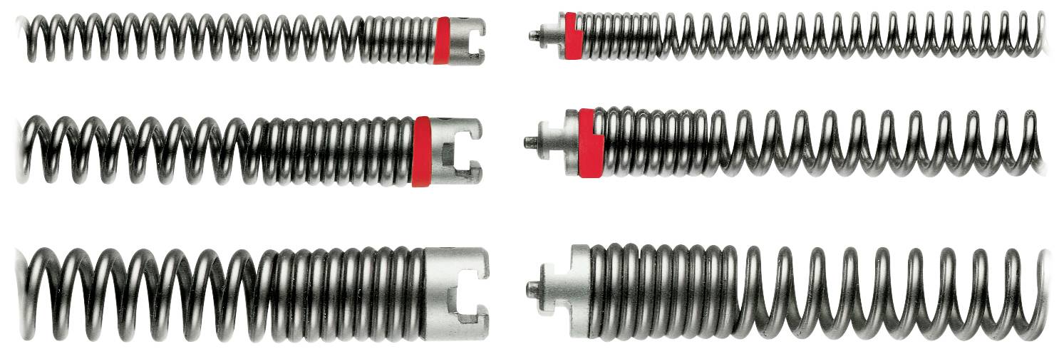 Verschiedene Metallfedern in einer Reihe, teils mit roten Markierungen, zeigen Unterschiede in Wicklung und Design.