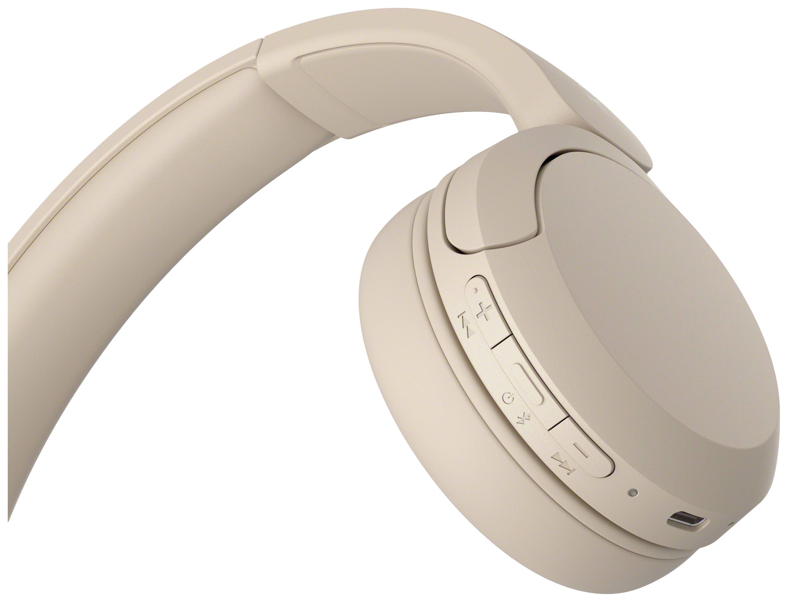 Beige Kopfhörer mit mehreren Bedienknöpfen an der Seite, zeigt modernes Design und drahtlose Funktion.