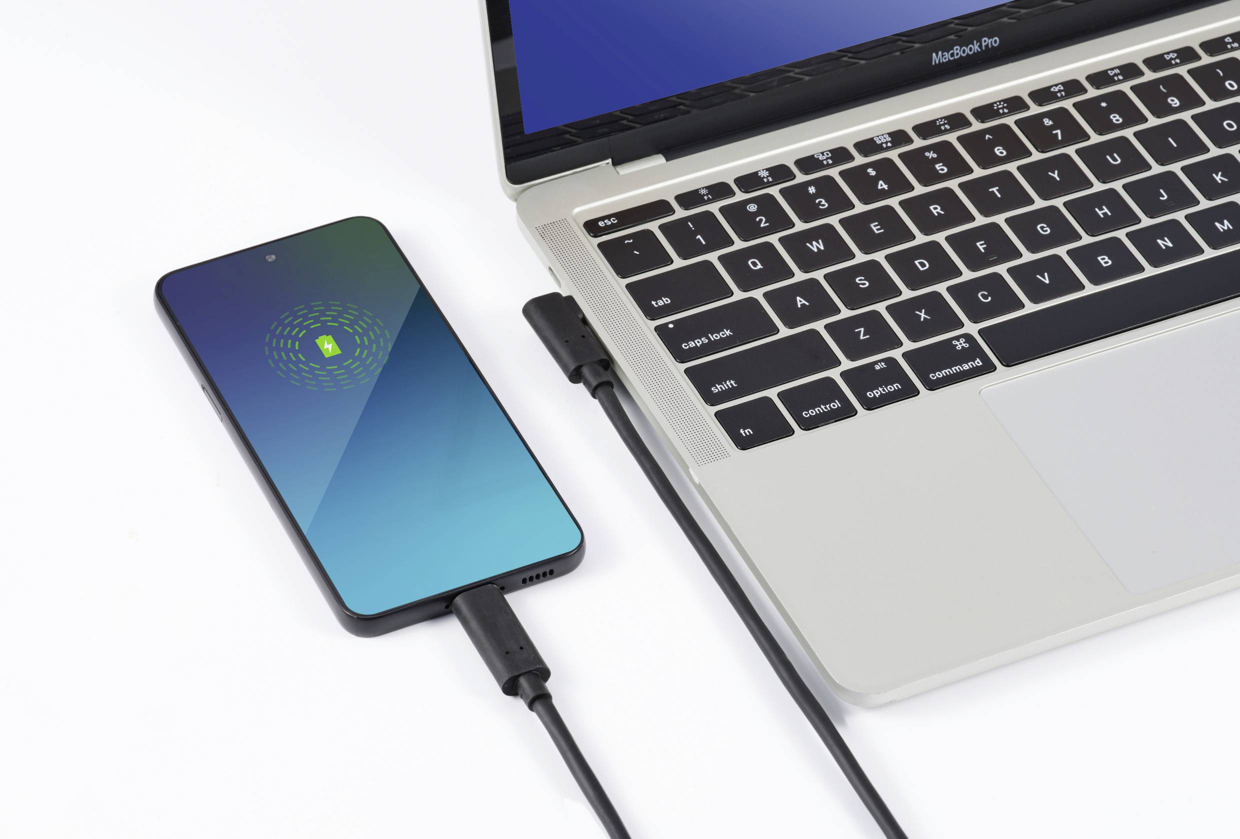 Ein Smartphone wird über ein USB-Kabel mit einem Laptop verbunden und aufgeladen. Der Ladebildschirm zeigt einen grünen Akku an.