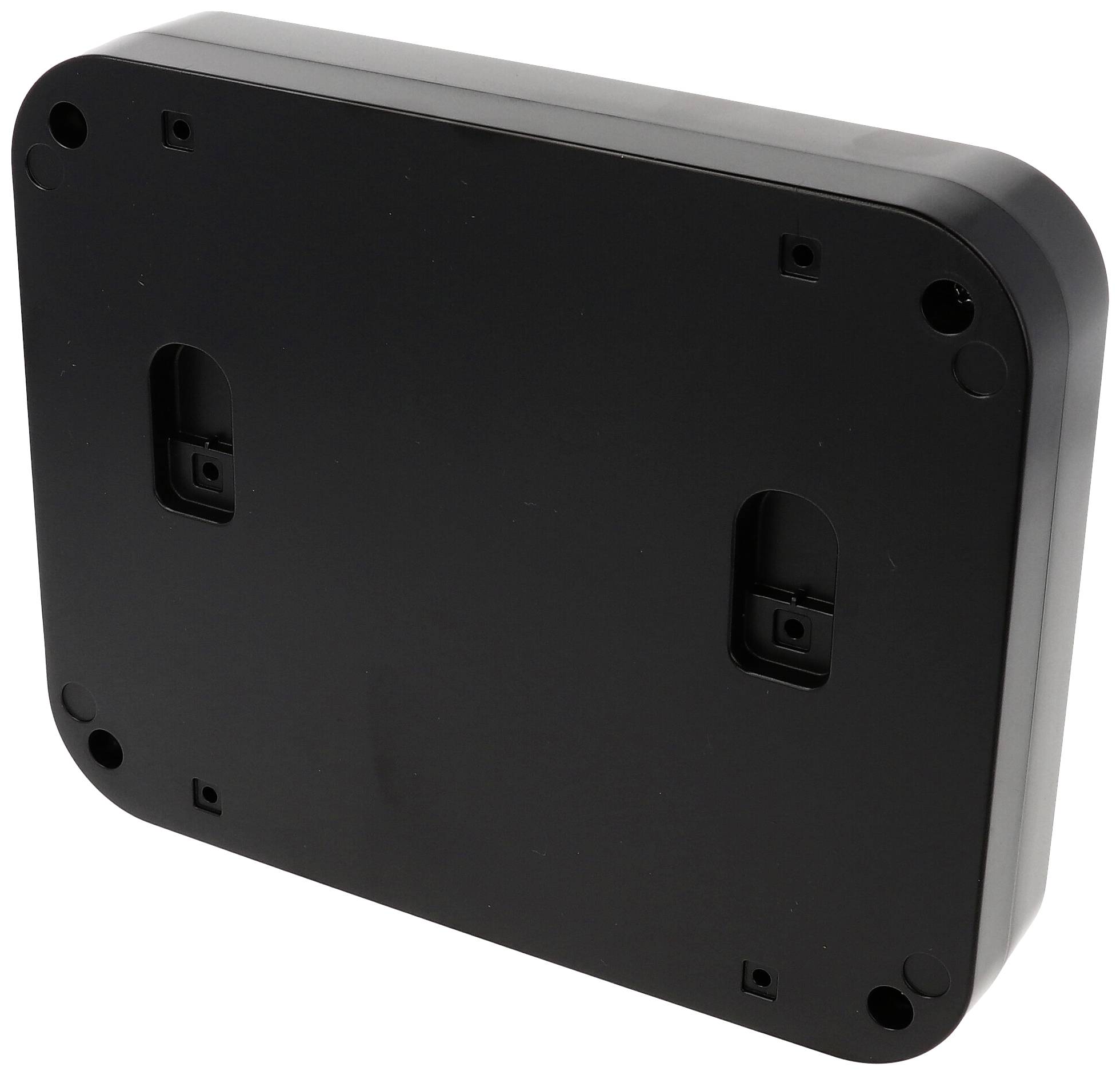Schwarzes rechteckiges Gehäuse, Rückansicht, mit abgerundeten Ecken und vier runden Schraubenlöchern an den Ecken.