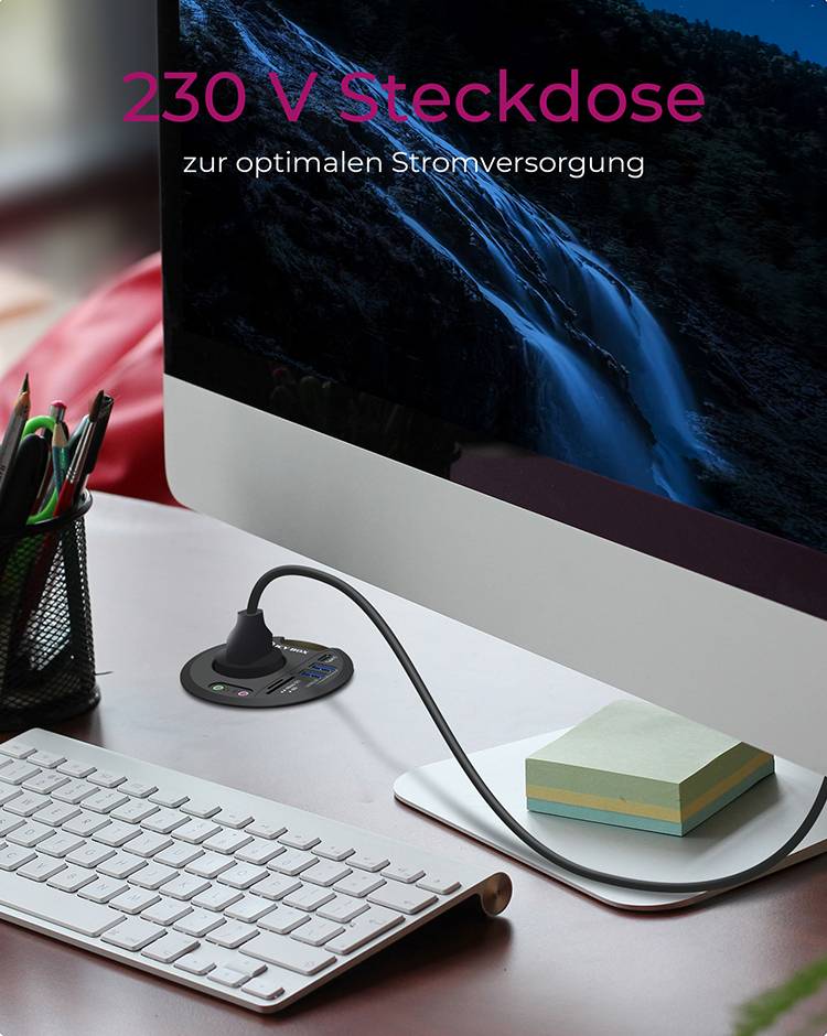 Ein Computerbildschirm auf einem Schreibtisch, verbunden mit einer 230 V Steckdose zur optimalen Stromversorgung. Bürobedarf daneben.