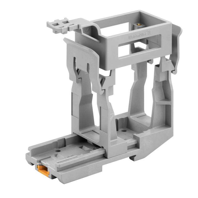 Ein grauer Kunststoffhalter in rechteckiger Form, möglicherweise ein Montagezubehör für elektrische Anwendungen.