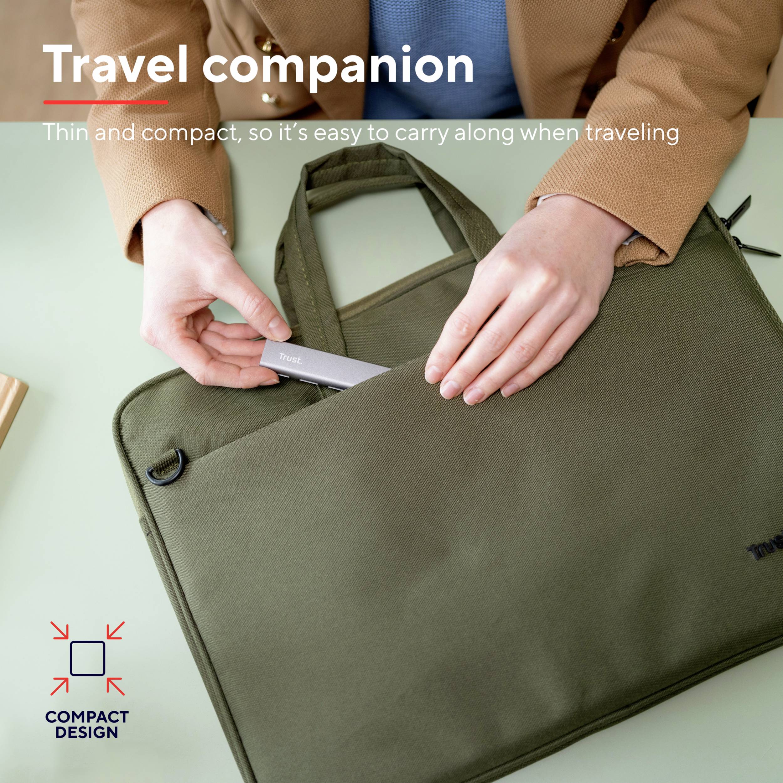Person hält eine kompakte grüne Tasche. Text: 'Travel companion. Thin and compact, so it's easy to carry along when traveling.'