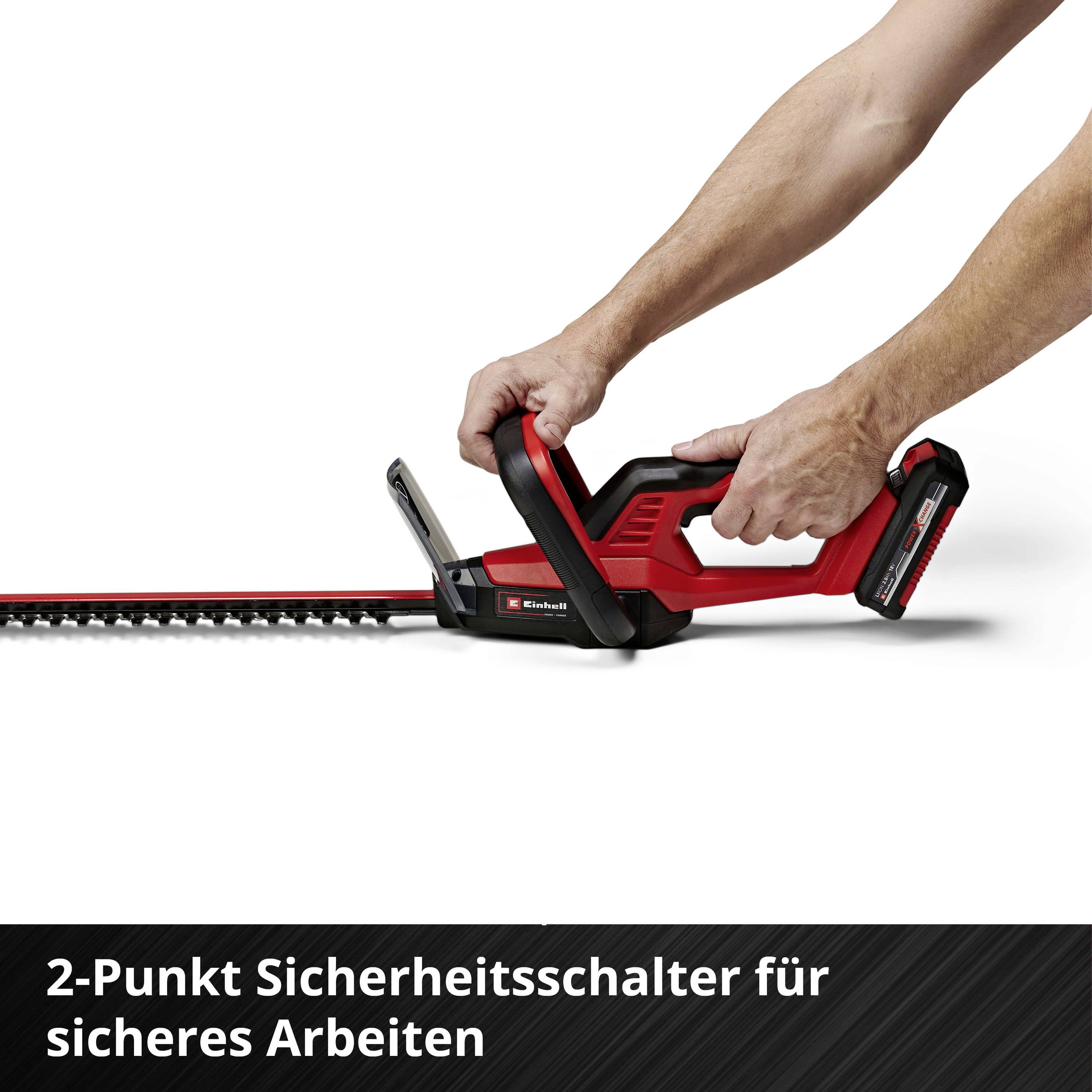 Heckenschere mit zwei Griffen und zweifarbigem Design. Text: '2-Punkt Sicherheitsschalter für sicheres Arbeiten'.