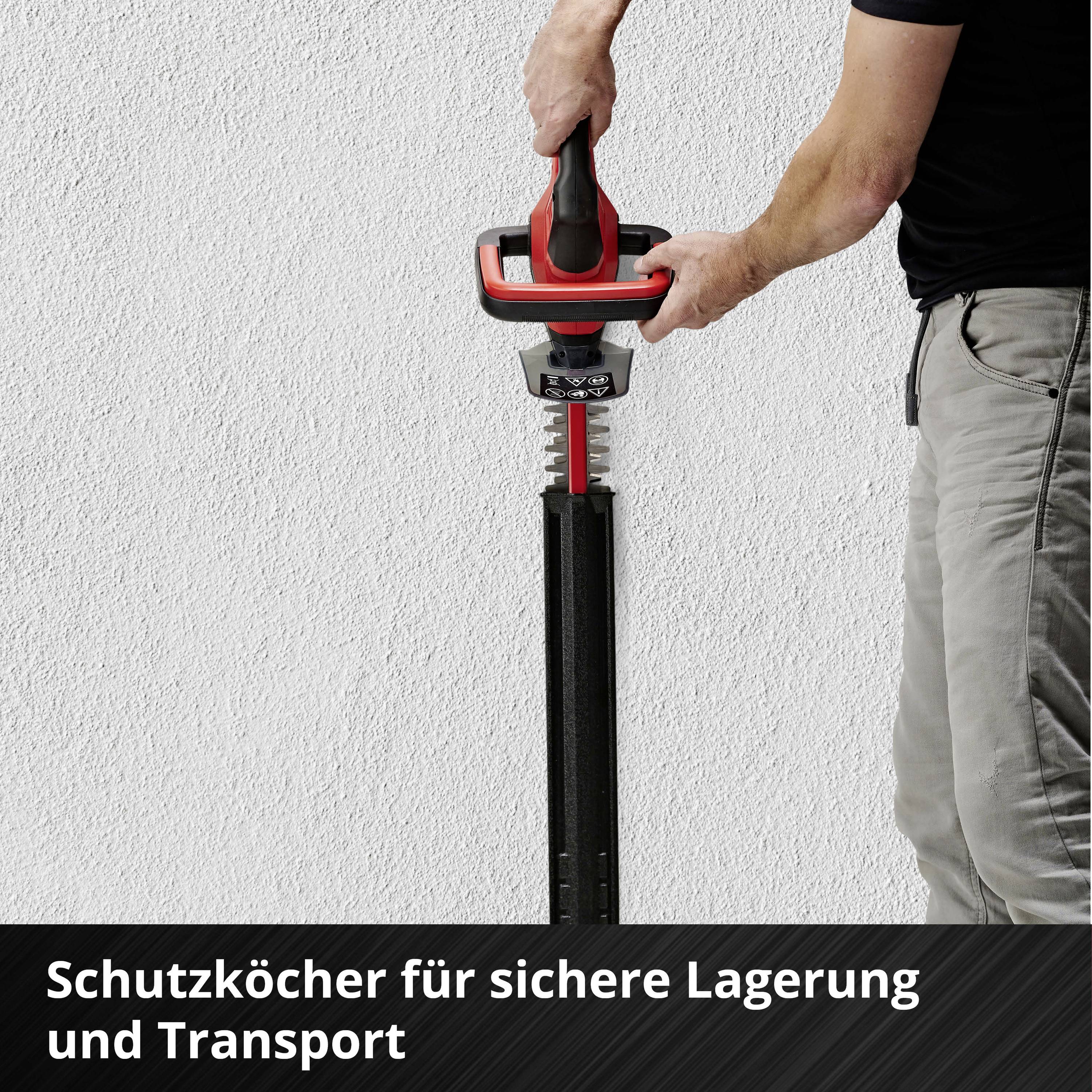 Person hält elektrisches Werkzeug mit Schutzklinge an der Wand. Text im Bild: 'Schutzköcher für sichere Lagerung und Transport'.