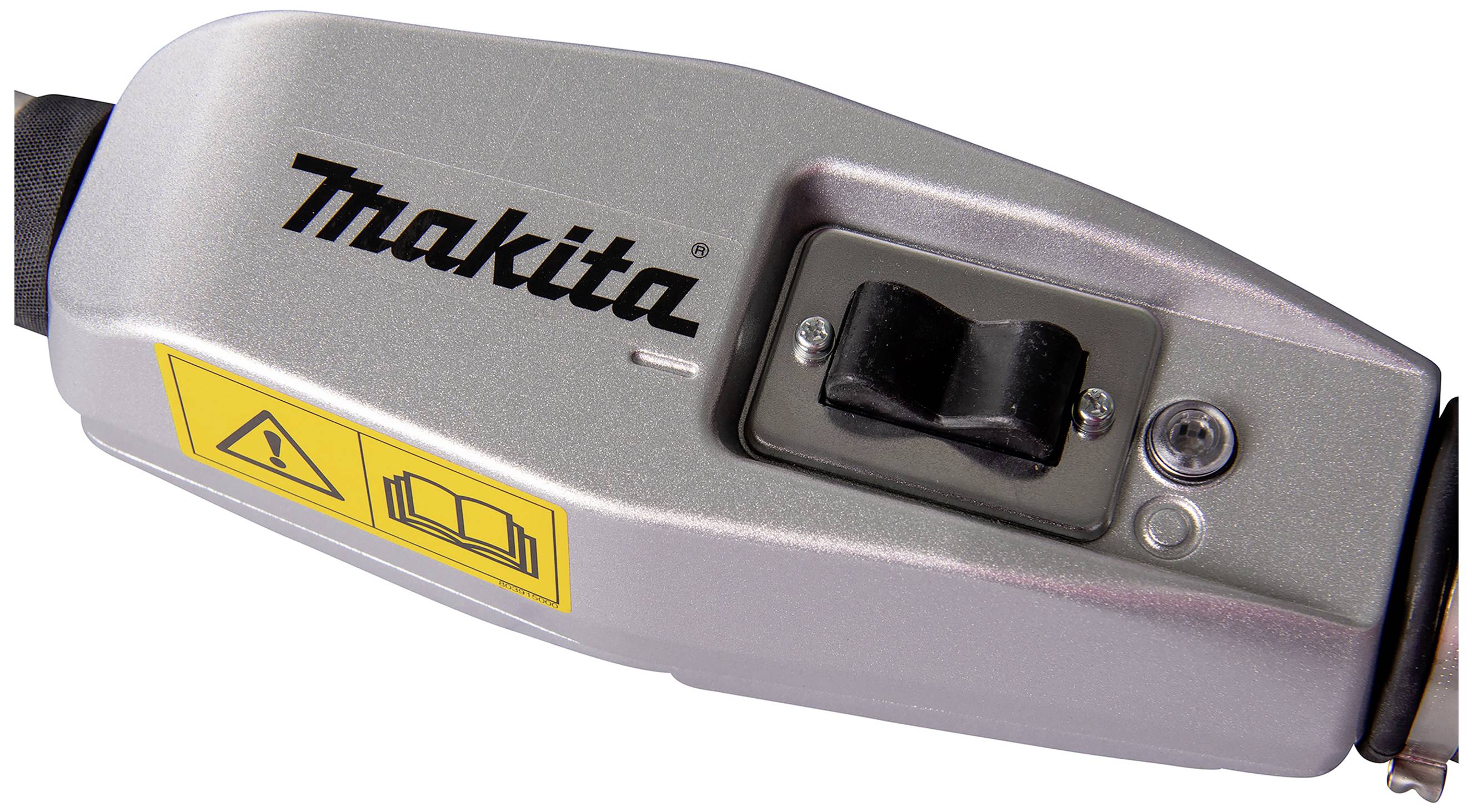 Nahaufnahme eines silbernen Geräts mit der Aufschrift 'Makita', einem Kippschalter und zwei Warnsymbolen daneben.