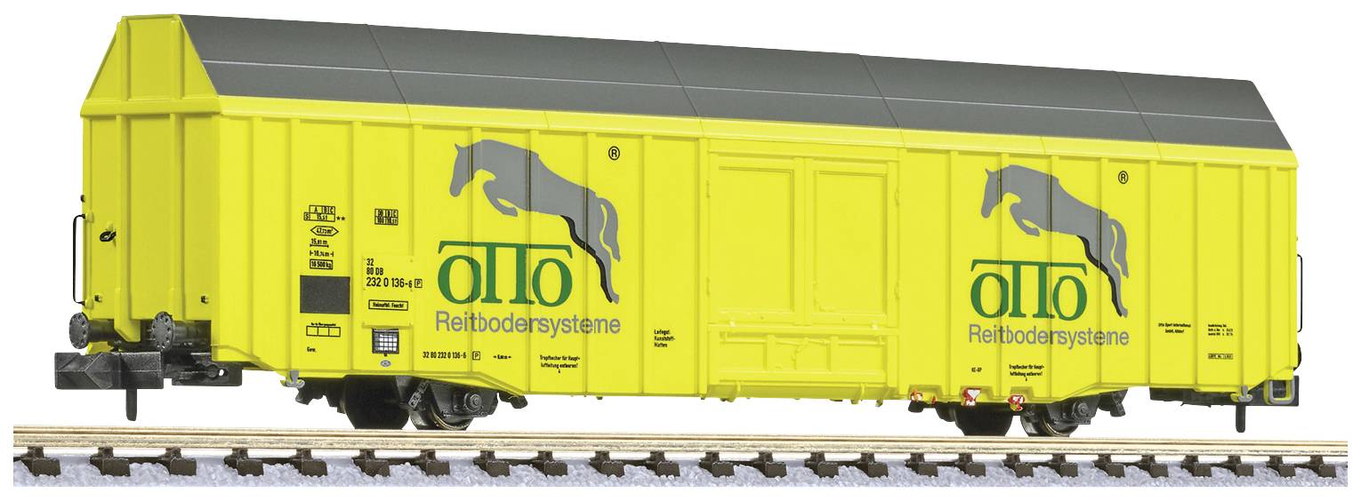 Gelber Eisenbahn-Güterwaggon mit schwarzem Dach und Aufdruck 'otto Reitsbodensysteme', Seitenansicht auf Schienen.