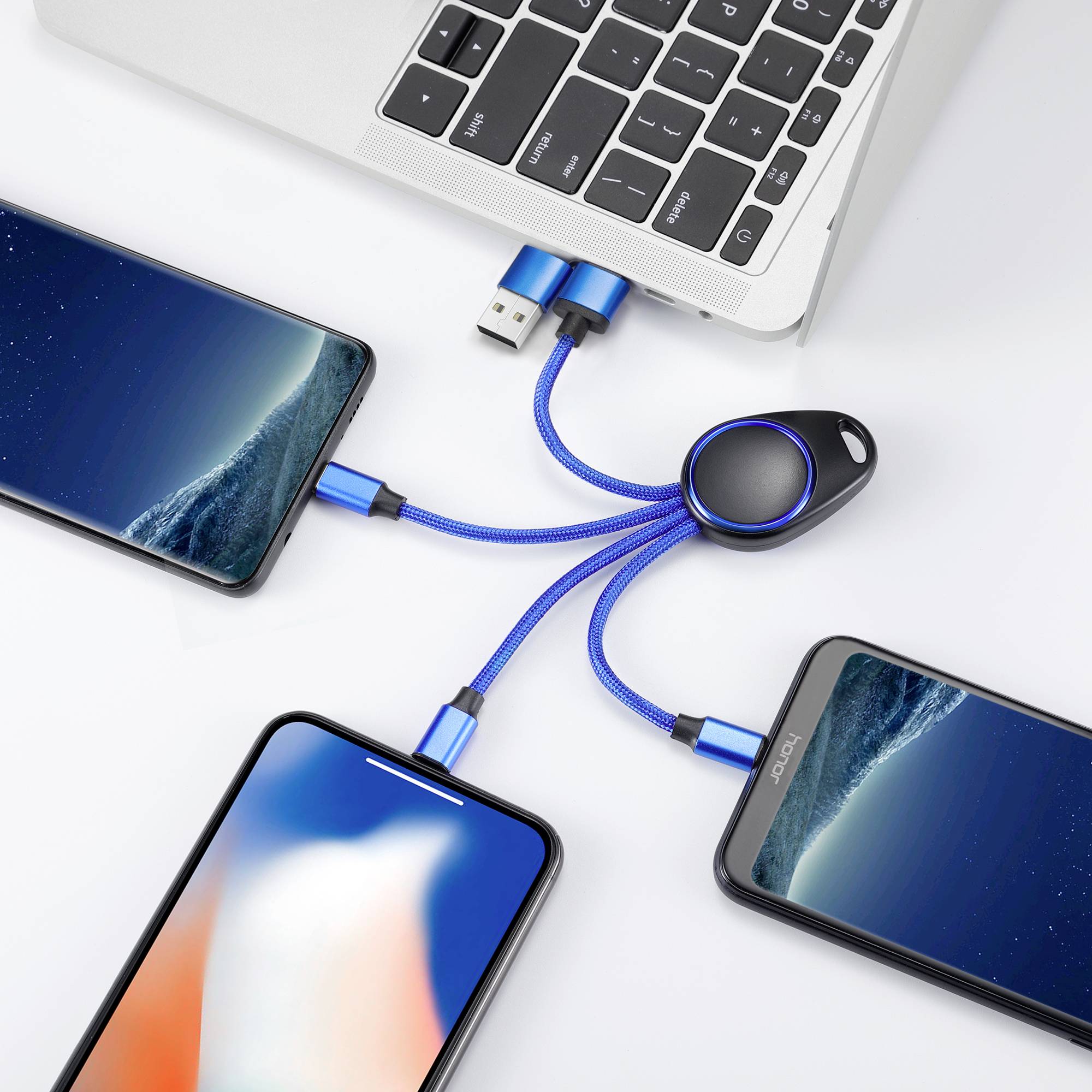 Ein Laptop ist mit drei Smartphones durch ein multifunktionales USB-Kabel verbunden, das über USB- und Lightning-Anschlüsse verfügt.