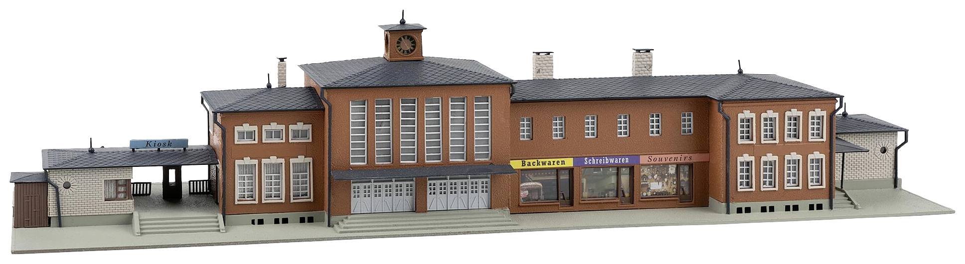 Ein Modell eines Bahnhofsgebäudes mit rotem Ziegelstein, Uhrturm und Schaufenstern. Details wie Treppen und Schilder sind sichtbar.