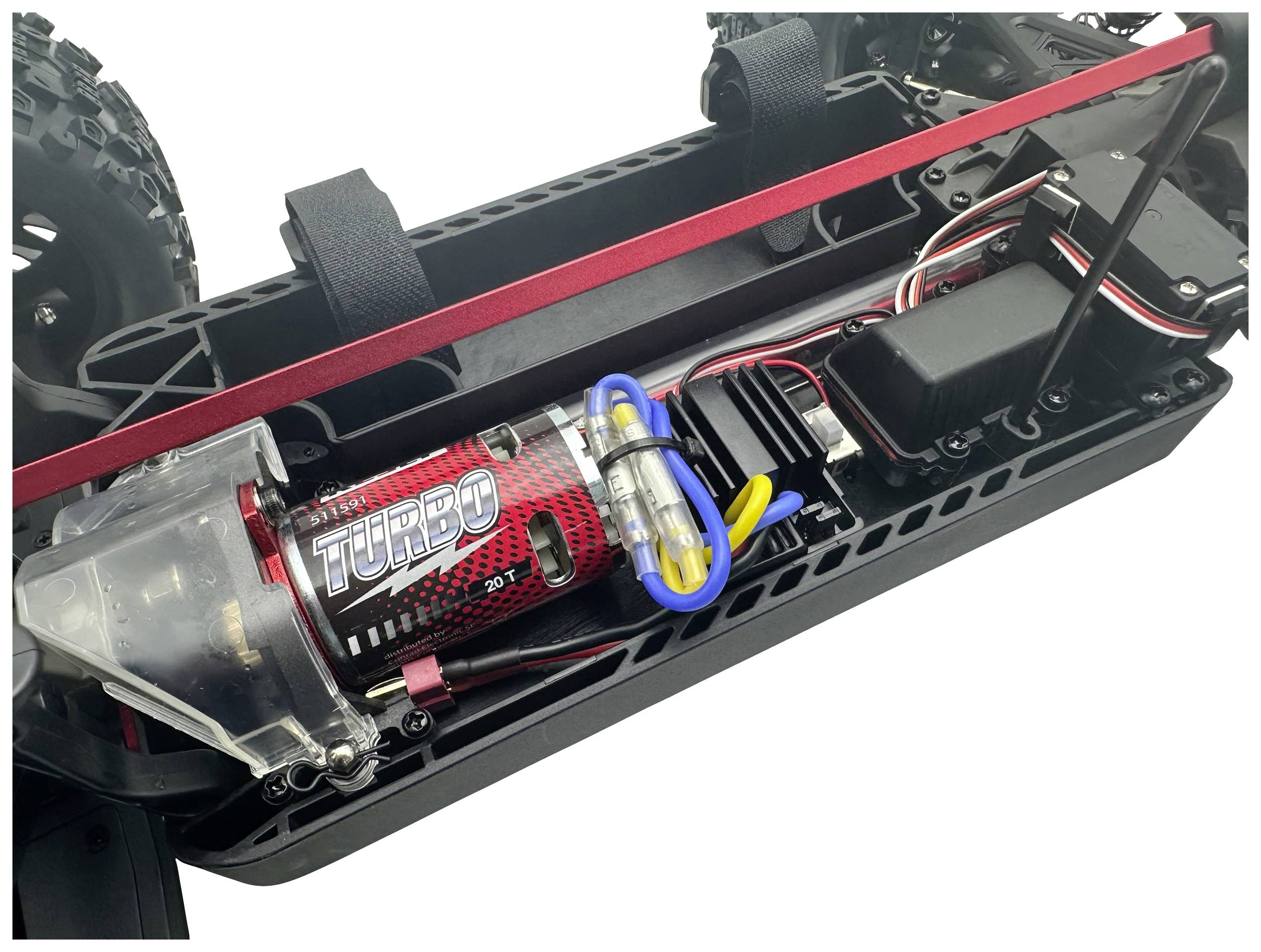 Nahaufnahme eines ferngesteuerten Autos mit offenem Chassis, das den Motor mit der Aufschrift 'Turbo' und elektronischen Komponenten zeigt.