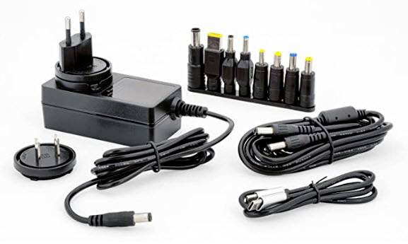 Vielseitiges Netzteil-Set mit verschiedenen Adaptern und Steckeraufsätzen für unterschiedliche Geräte, inklusive Netzkabel.