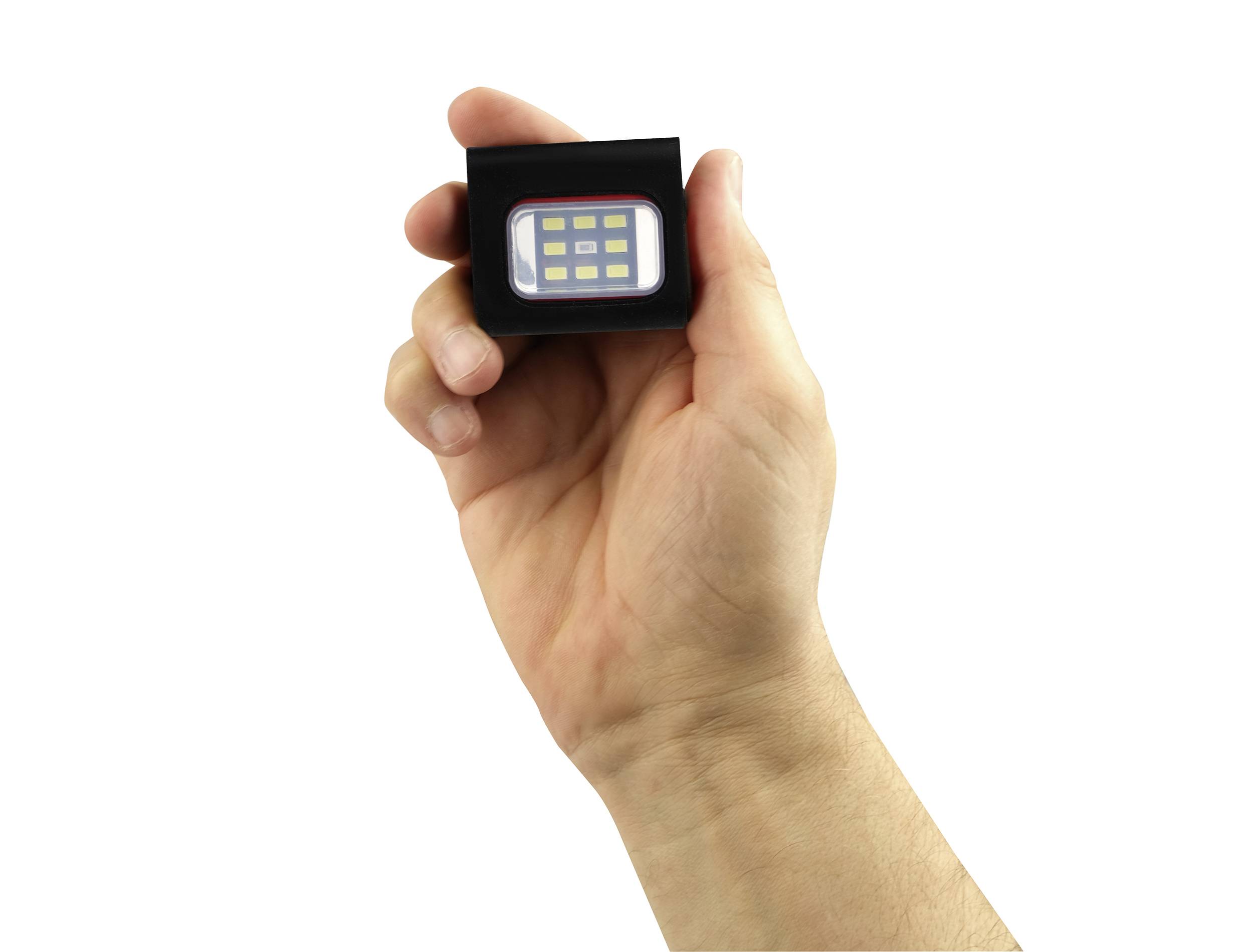 Eine Hand hält ein kleines, rechteckiges LED-Licht mit mehreren gelben Dioden in einem schwarzen Gehäuse.