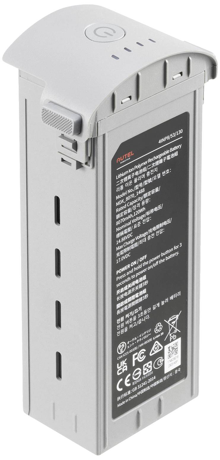 Graue Batterie mit technischen Informationen und Symbolen. Oberseite hat einen runden Power-Knopf.