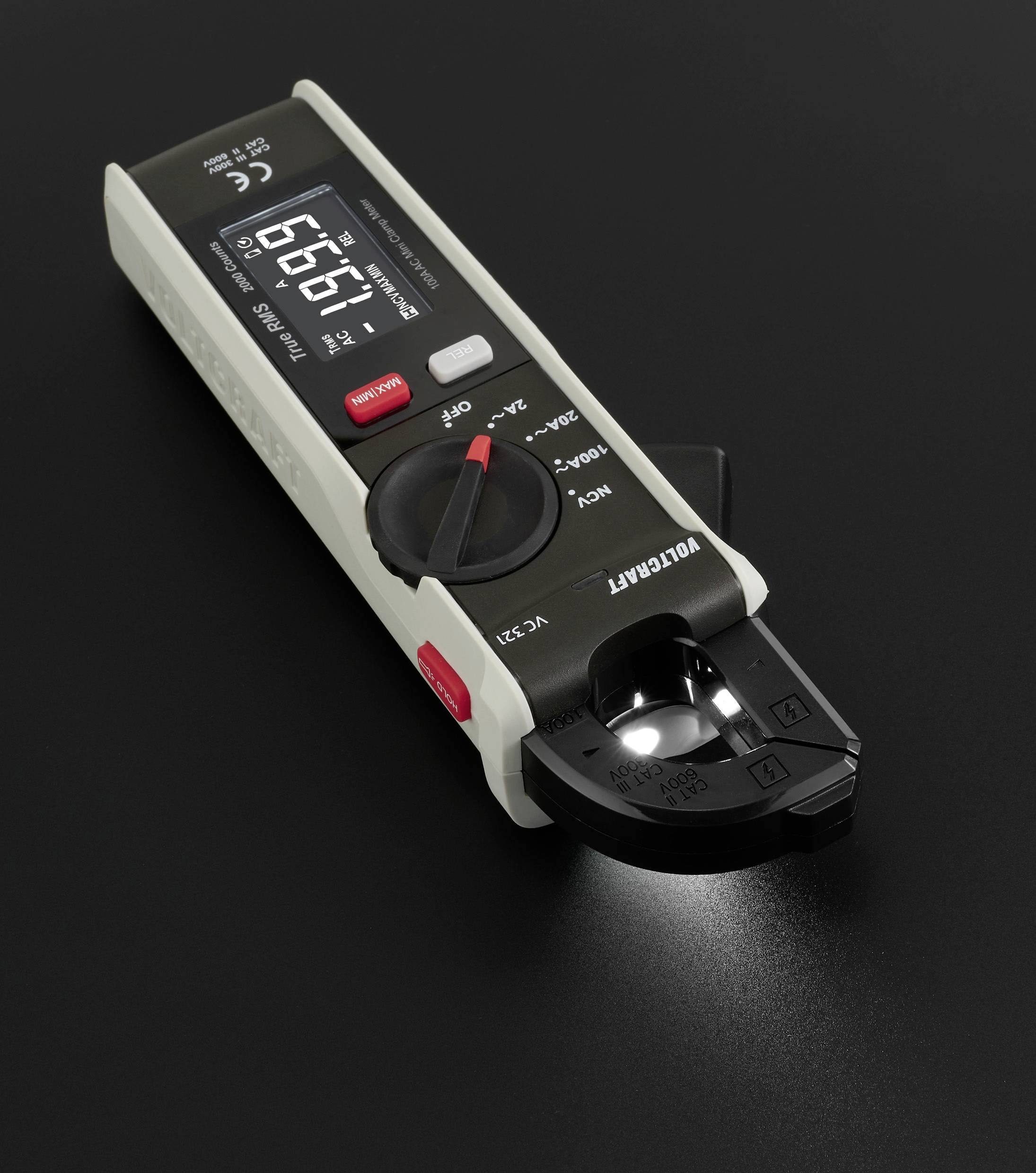 Ein digitales Multimeter mit LCD-Anzeige zeigt '9.67' an. Es hat einen Drehschalter für verschiedene Messmodi und eine LED-Leuchte.