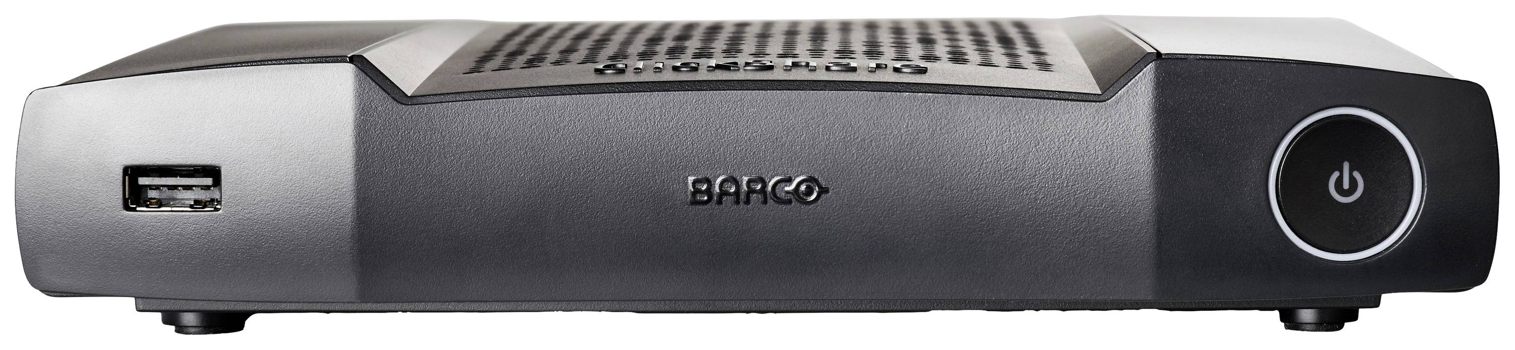 Ein schwarzer digitaler Receiver mit einem USB-Anschluss links und einem beleuchteten Ein-/Aus-Schalter rechts. Im Zentrum steht 'Barco'.