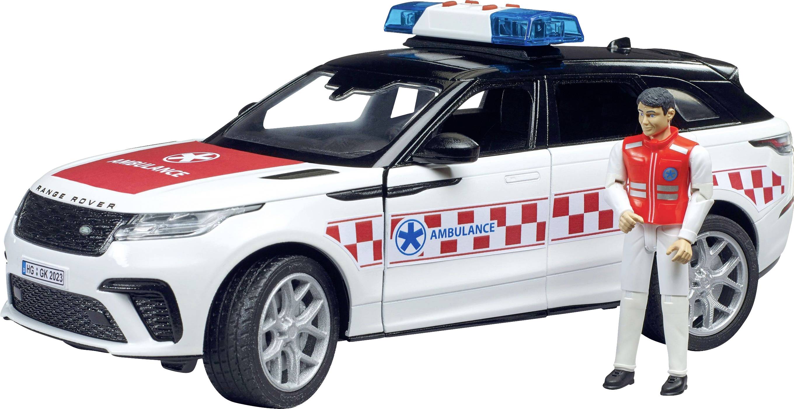 Spielzeug Krankenwagen mit Figurenfahrer in roter Rettungsweste daneben. Fahrzeug in Weiß mit rotem Muster und 'Ambulance'-Schriftzug.