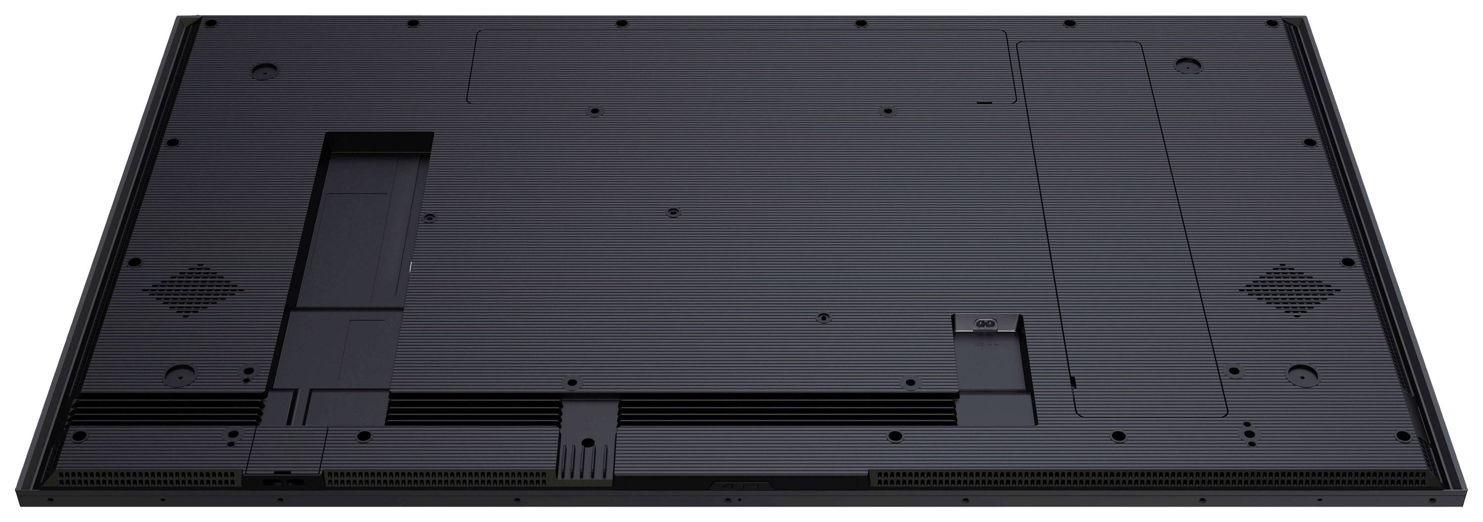 Rückseite eines elektronischen Geräts mit schwarzen Gehäuse, flachen Design und Lüftungsschlitzen, evtl. für Bildschirm oder Fernseher.