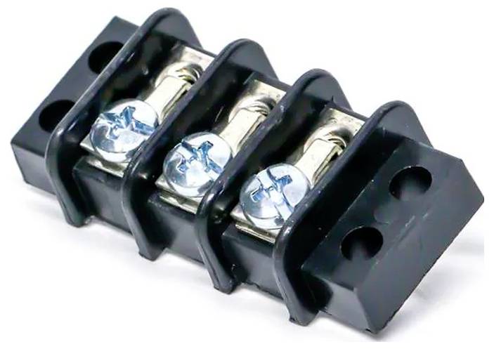 Ein schwarzer dreipoliger Klemmblock mit silbernen Schrauben und Befestigungslöchern, verwendet für elektrische Verbindungen.