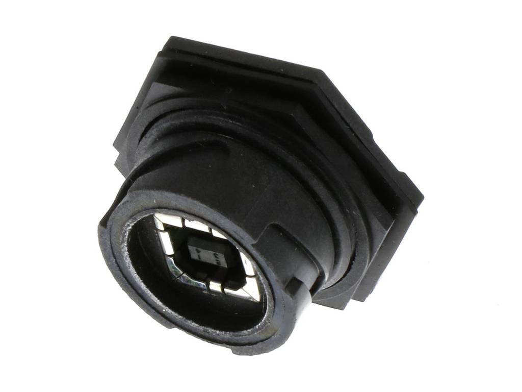 Ein schwarzer, sechseckiger Sensor mit Metallteilen und elektronischen Komponenten, wahrscheinlich für ein Gerät oder eine Maschine.