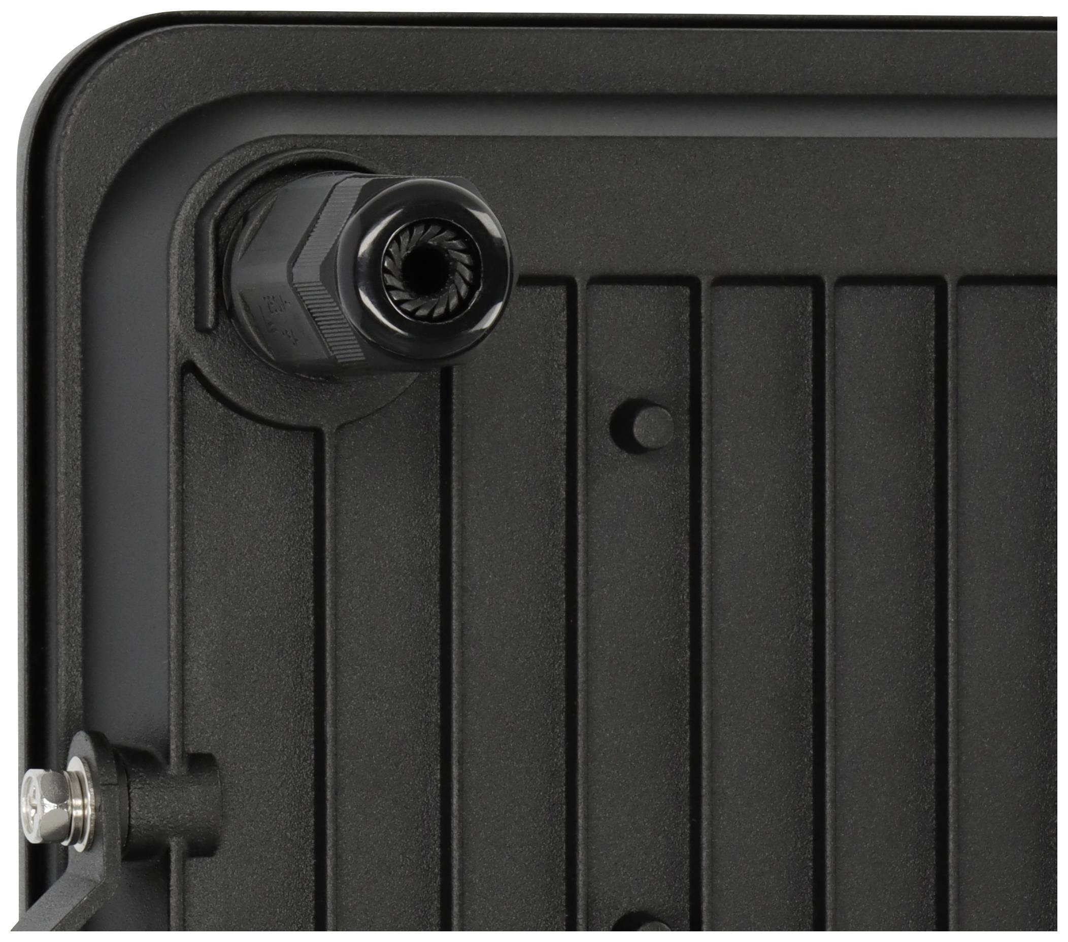 Ein schwarzes, rechteckiges Objekt mit geriffelter Oberfläche und einer Befestigungsschraube in einer Ecke.