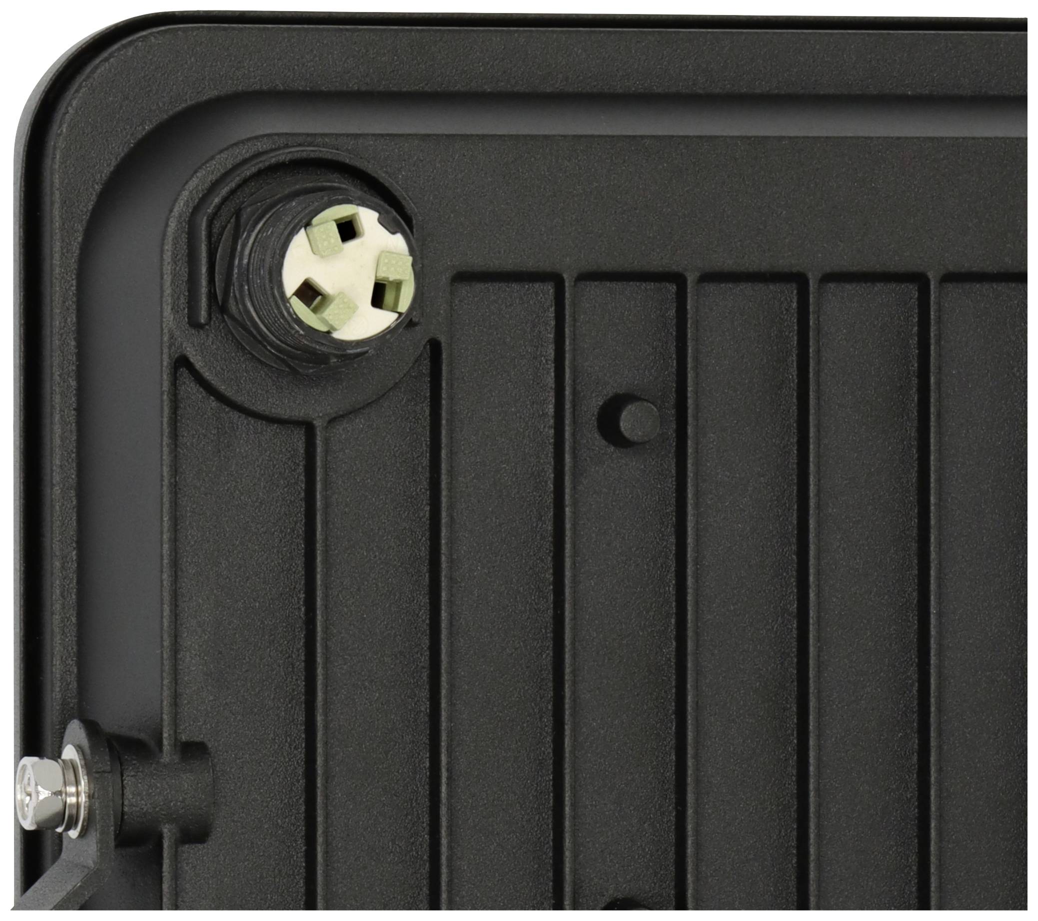 Ein Ausschnitt eines schwarzen Paneels mit Schrauben und einem runden Anschluss an der Ecke.