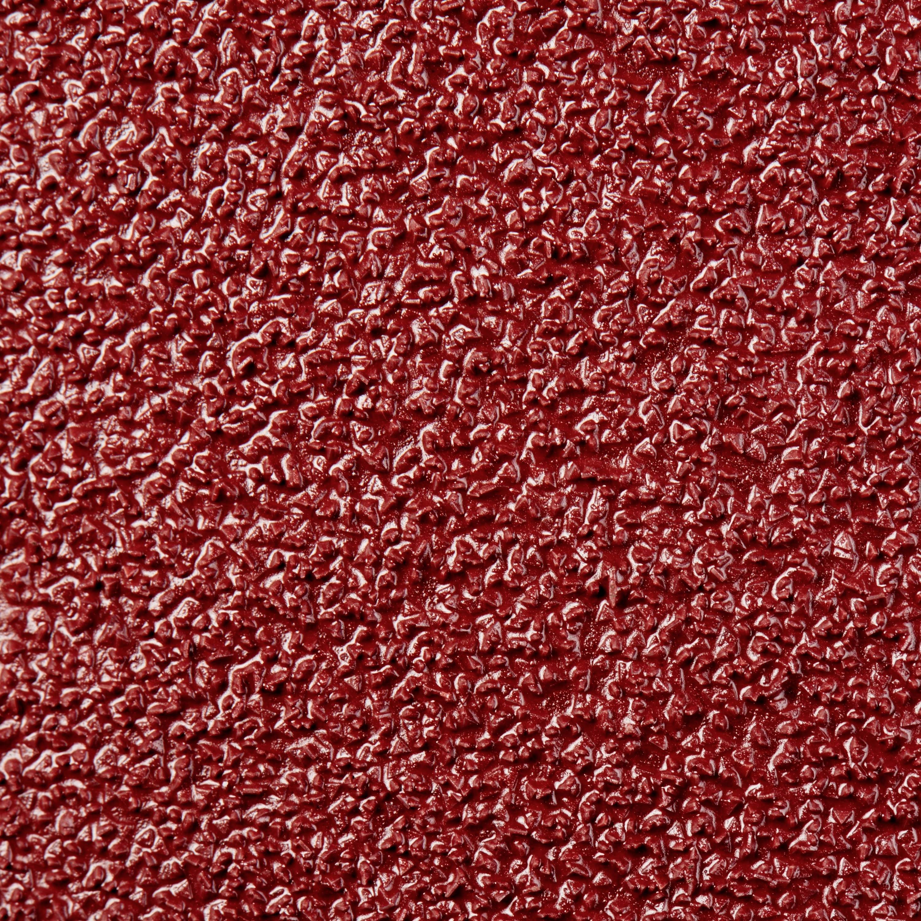 Rote, raue Oberfläche, ähnlich grobem Sandpapier, zeigt eine gleichmäßige Textur mit kleinen Erhebungen und Vertiefungen.