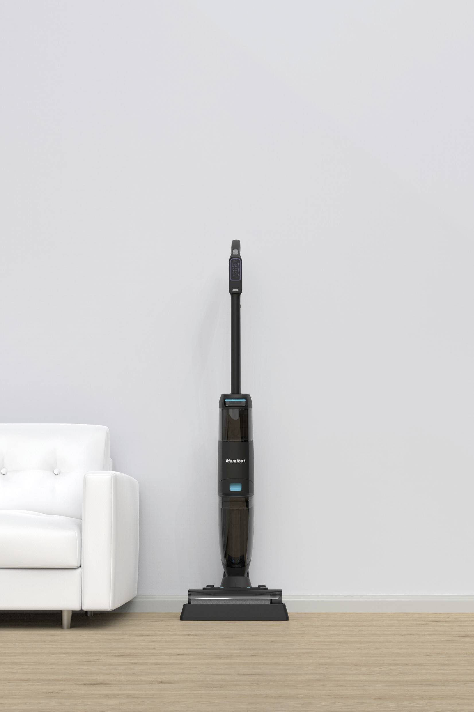 Ein schwarzer Staubsauger steht aufrecht auf einem Holzfußboden neben einem weißen Sofa vor einer hellgrauen Wand.