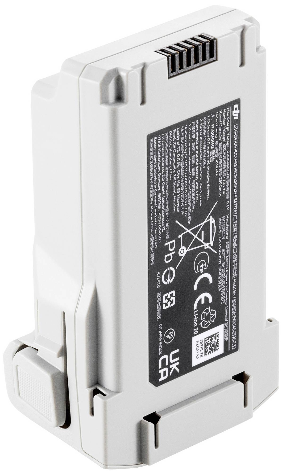 Eine graue Drohnenbatterie mit schwarzen Etiketten und Symbolen, die auf nicht korrekte Entsorgung hinweisen.