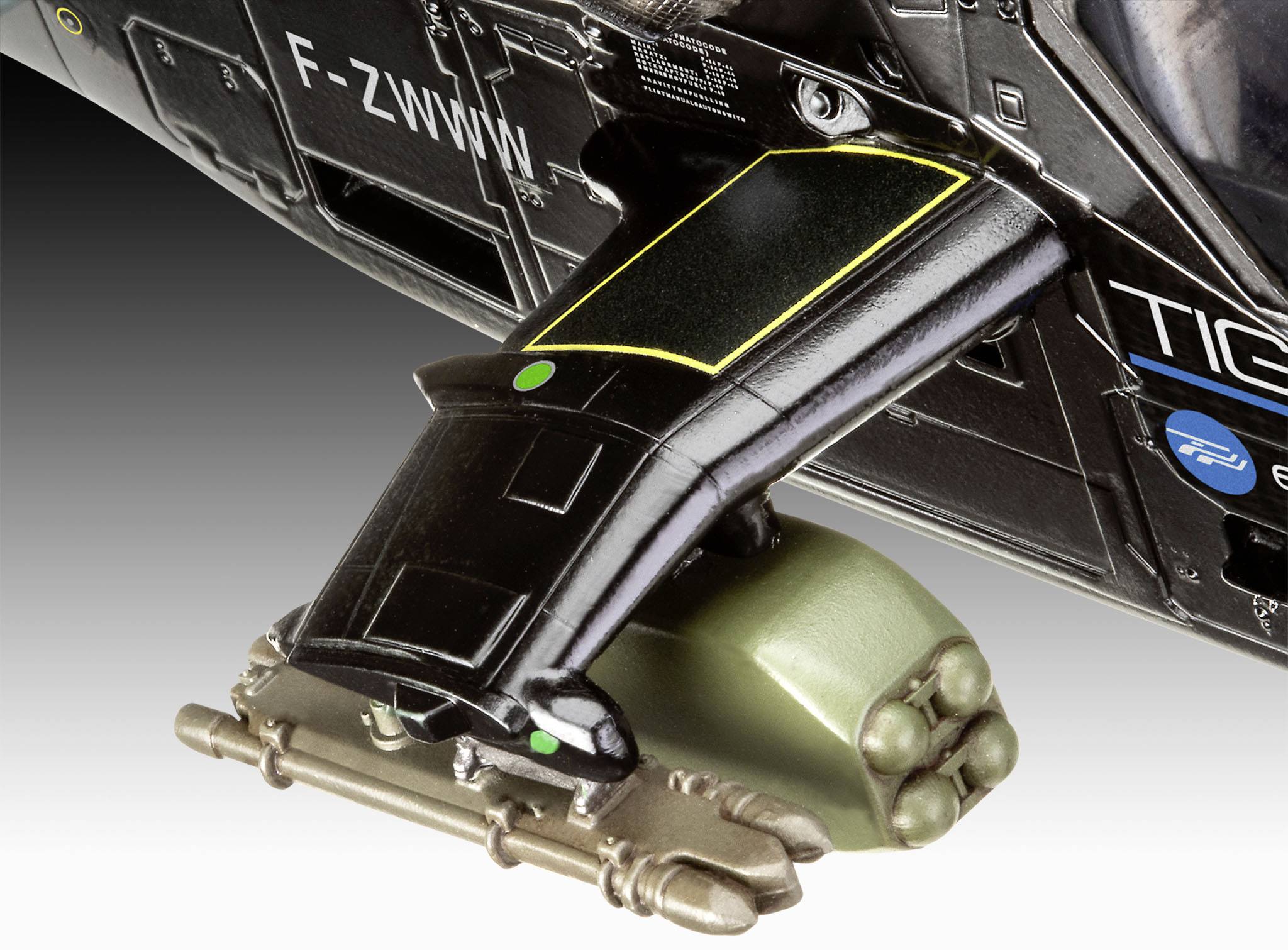 Nahaufnahme eines Hubschrauber-Modells mit detailliertem Raketenbündel unter dem Flügel montiert, zeigt technische Merkmale.