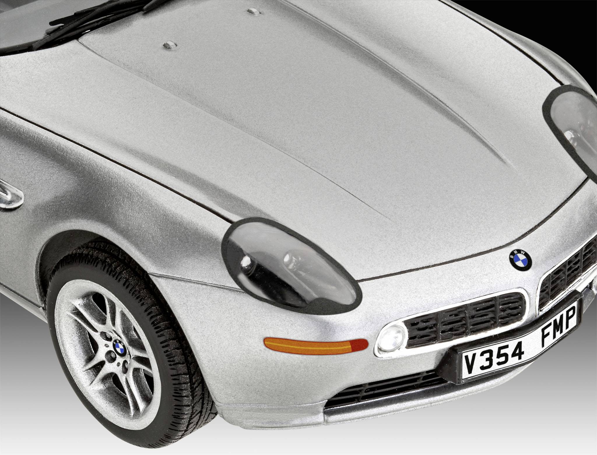 Silbernes Modellauto eines Sportwagens, Vorderansicht, auf grauem Hintergrund.