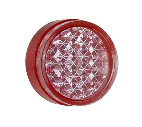 Rundes, rotes Rücklicht mit reflektierendem, diamantartigem Muster in der Mitte.