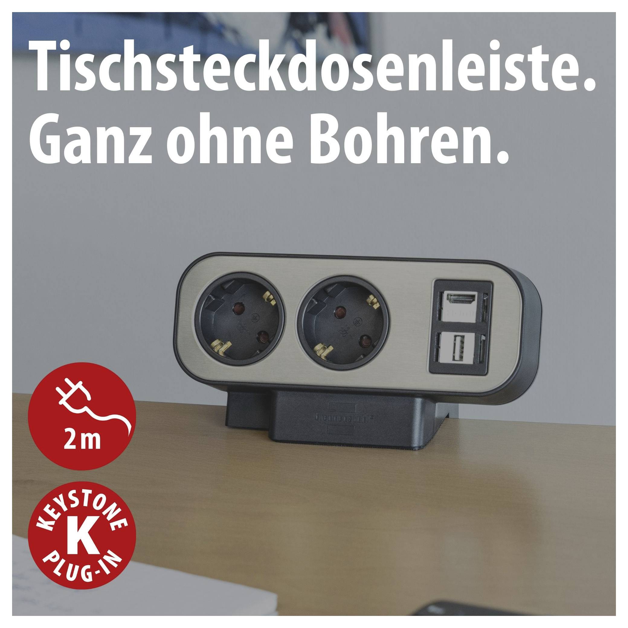 Werbebild einer Tischsteckdosenleiste mit zwei Steckdosen und USB-Anschlüssen; Text: 'Tischsteckdosenleiste. Ganz ohne Bohren.' sowie '2 m' und 'KEYSTONE K plug-in'.