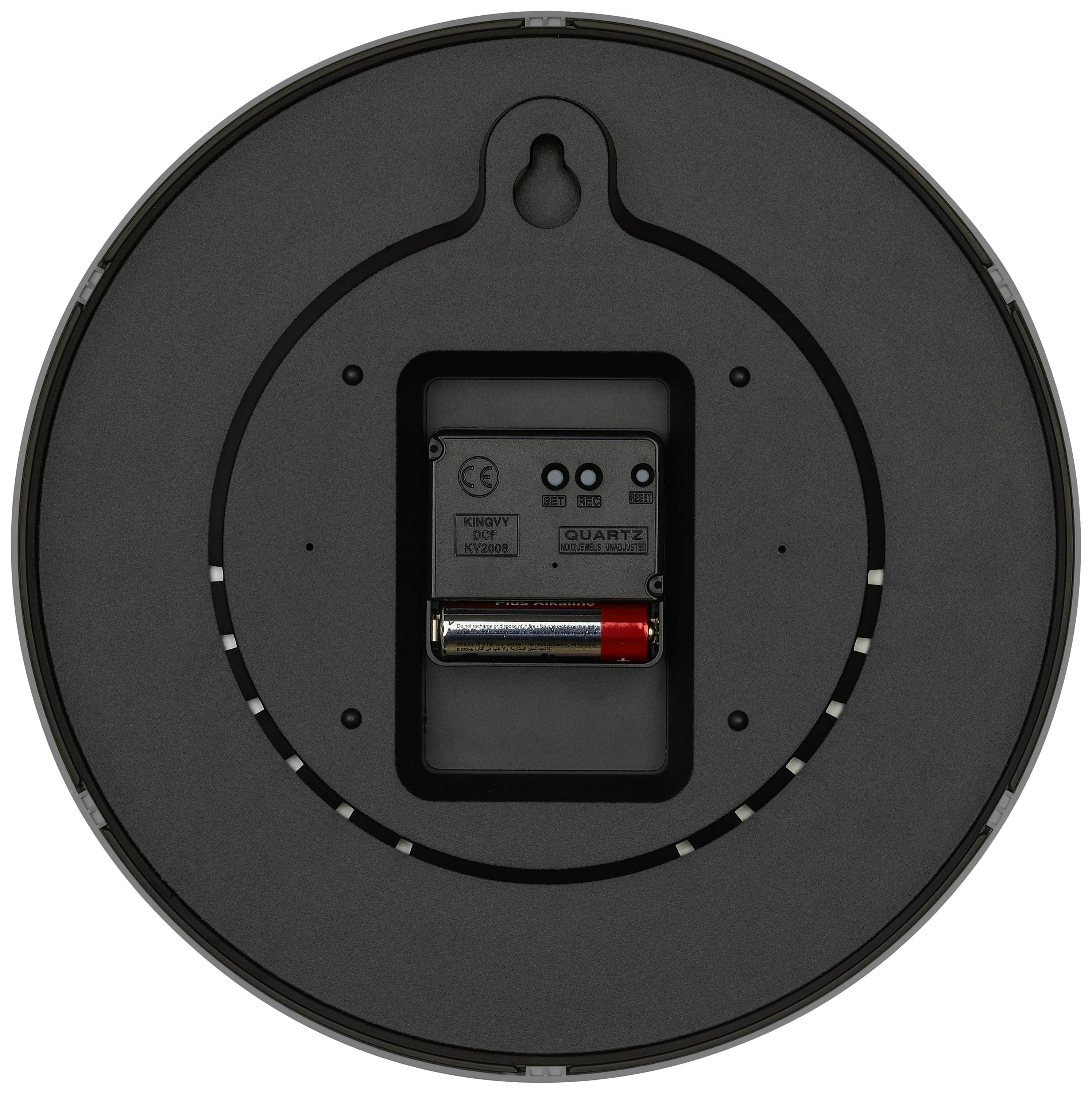 Rückseite einer Wanduhr mit Batteriefach und Quarzuhrwerk sichtbar. Eine AA-Batterie ist eingesetzt. Keine weiteren Details erkennbar.