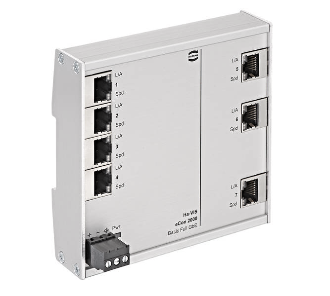 Ein silberner Ethernet-Switch mit acht RJ-45-Ports, nummeriert von 1 bis 8. Links unten ein kleiner schwarzer Stromanschluss.