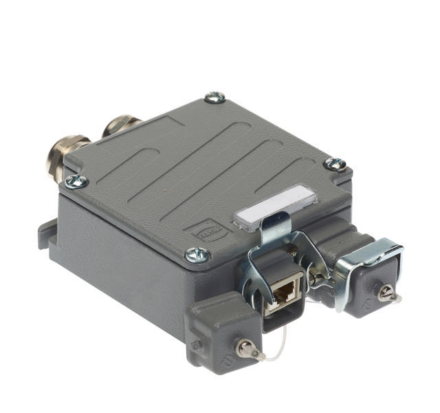 Ein graues, rechteckiges Elektromodul mit mehreren Anschlüssen und Schraubbefestigungen, geeignet für industrielle Anwendungen.