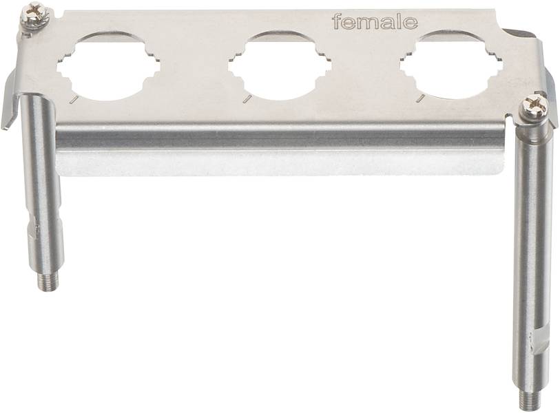 Metallplatte mit drei Aussparungen, auf der 'female' eingraviert ist, und zwei Befestigungsstangen an den Seiten.
