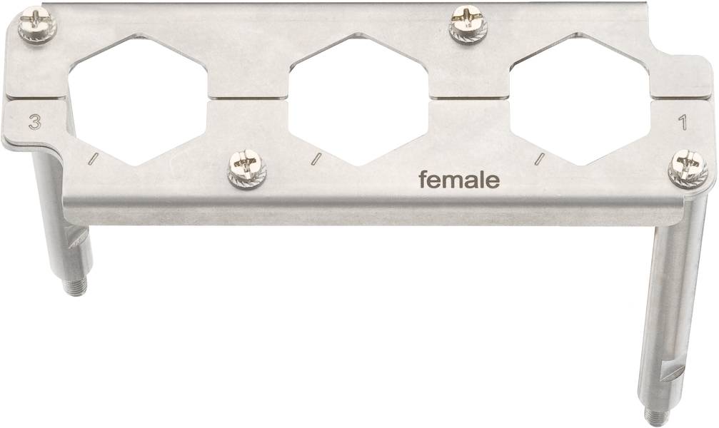 Metallhalterung mit drei hexagonalen Öffnungen, beschriftet mit 'female', Schrauben an den Ecken zur Befestigung.