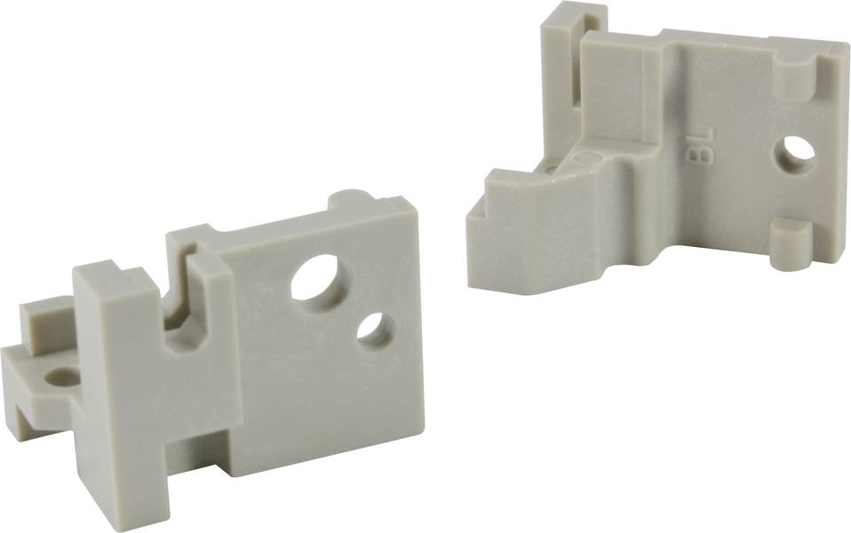 Zwei beige Metallhalterungen mit verschiedenen Aussparungen und Löchern.
