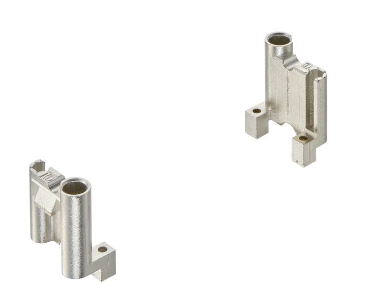Zwei metallische Bauteile mit rechteckigen und zylindrischen Formen, voneinander getrennt, vor einem weißen Hintergrund.