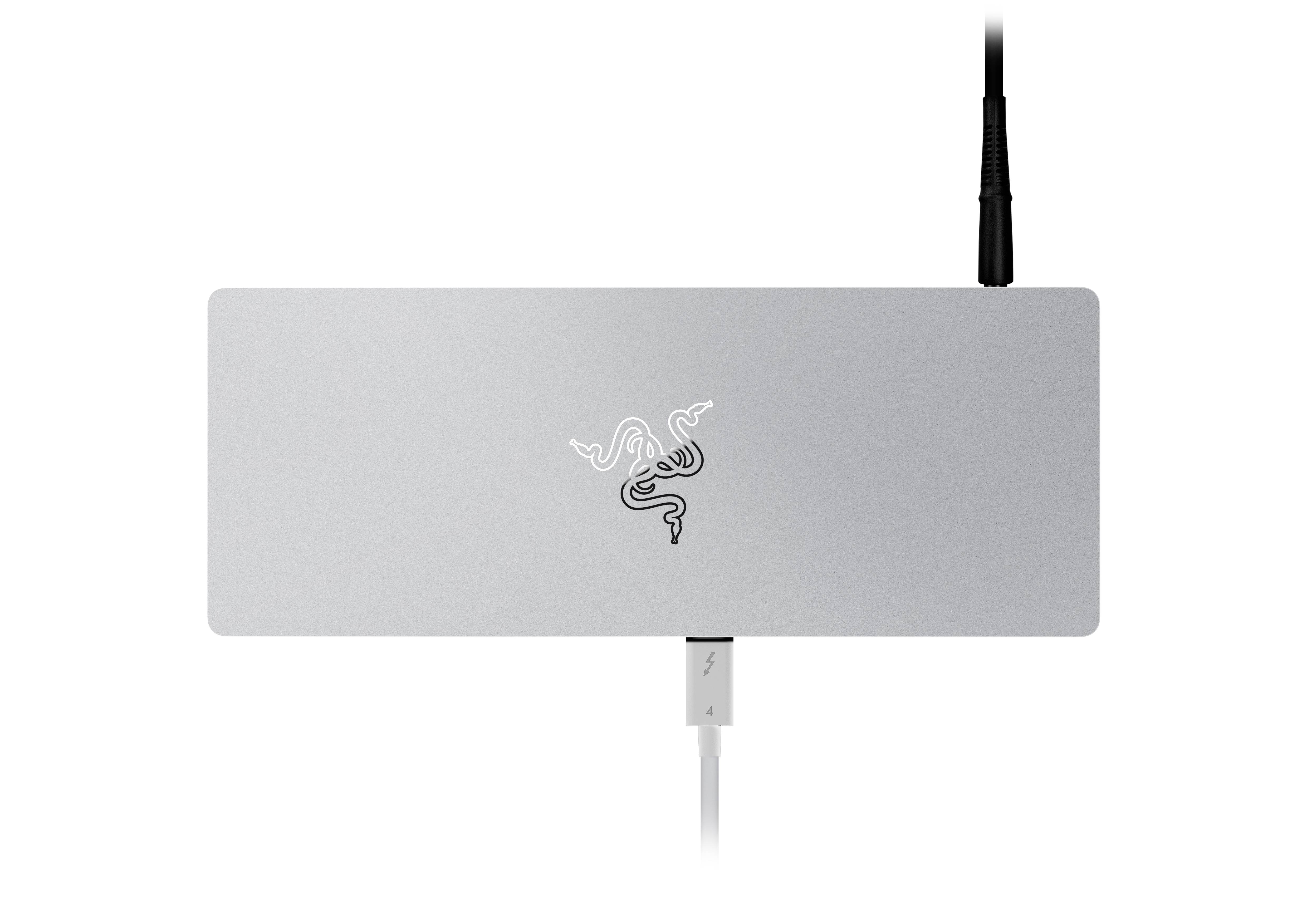 Elegantes silbernes Gerät mit Schlangensymbol in der Mitte, zwei Kabelanschlüsse oben und unten. Minimalistisches technisches Design.