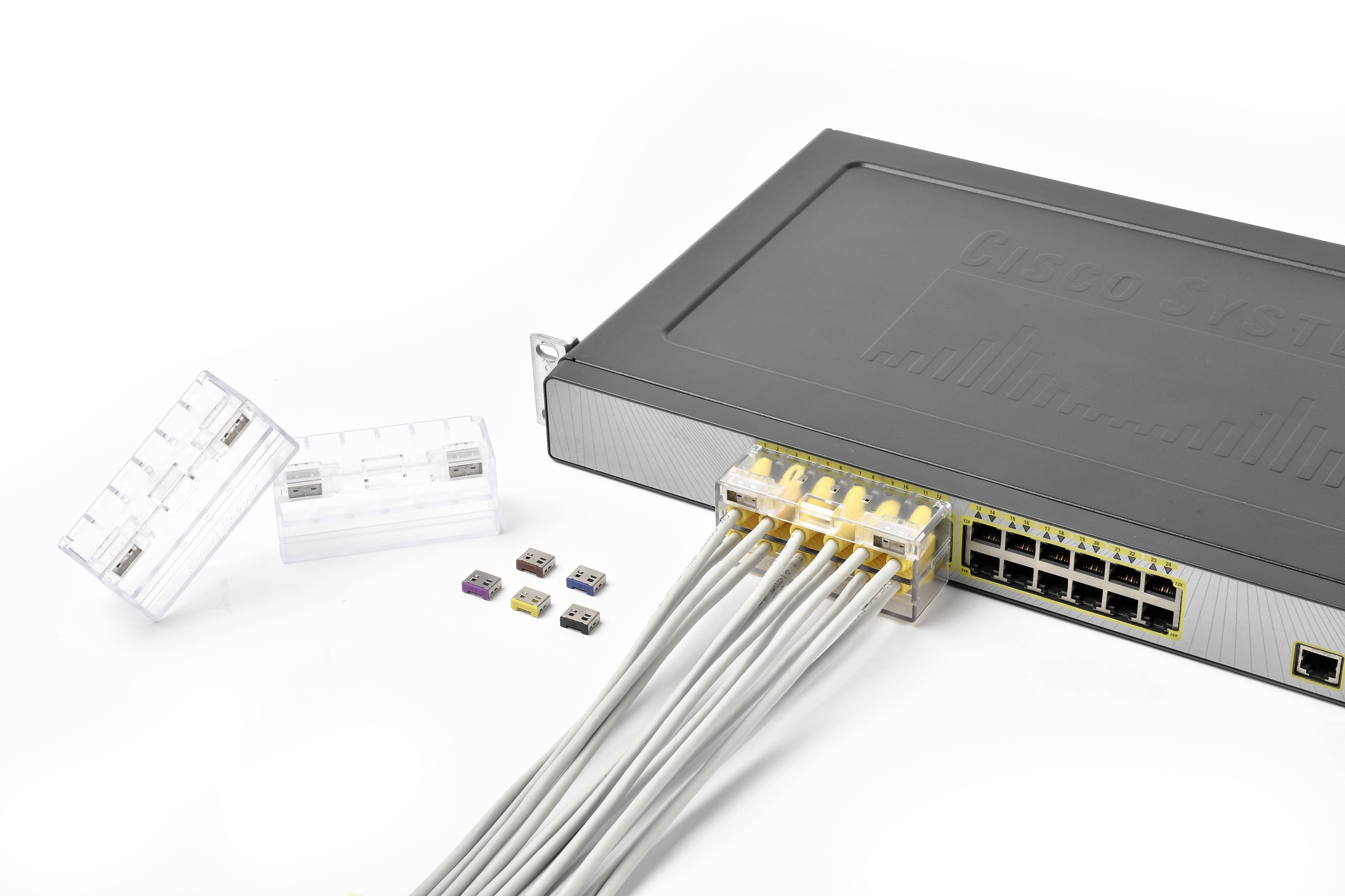 Ein Netzwerk-Switch mit acht angeschlossenen Ethernet-Kabeln und mehreren SIM-Karten in verschiedenen Größen daneben.