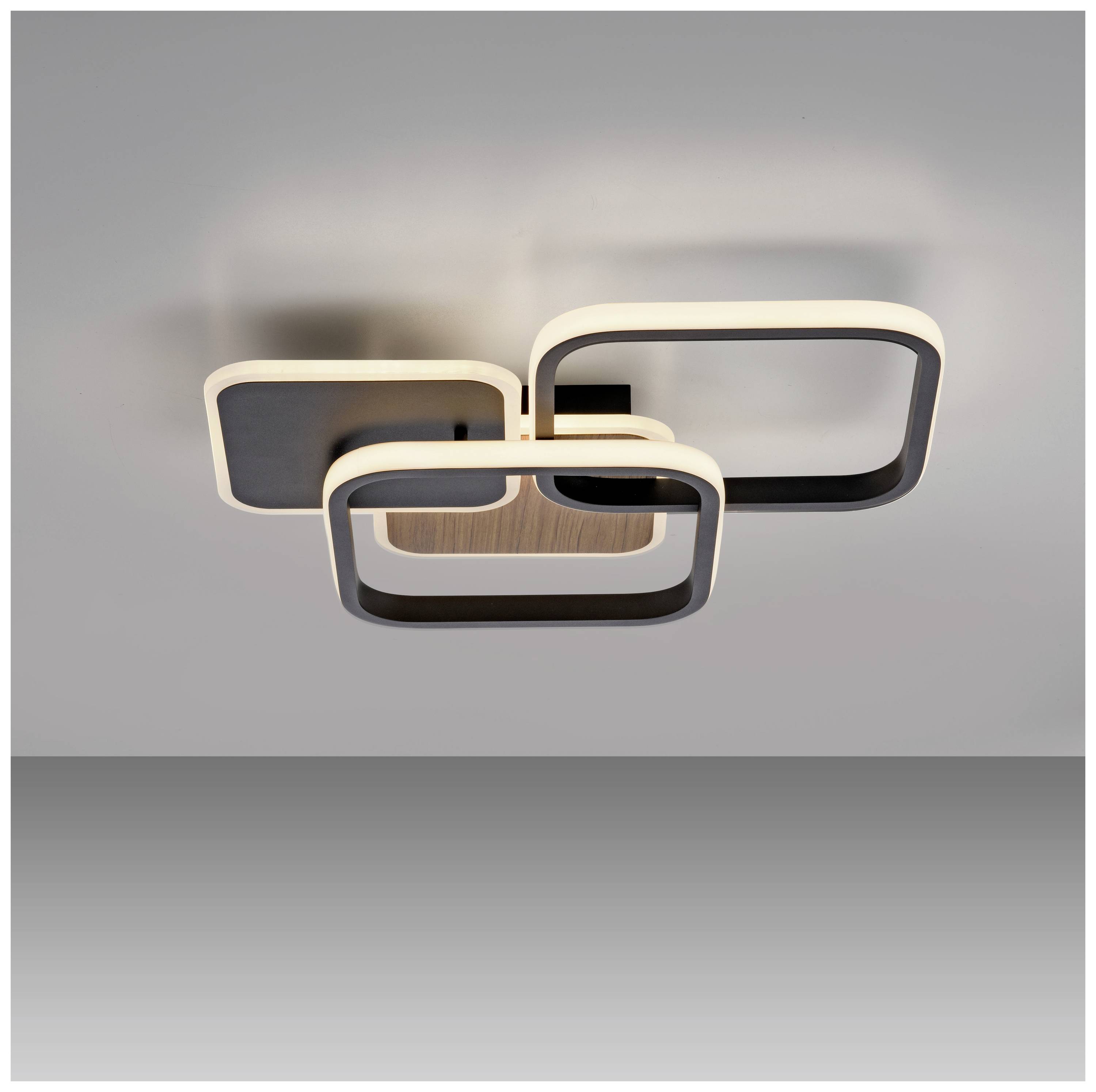 Moderne Deckenleuchte mit rechteckigen, versetzten LED-Rahmen in Schwarz und Weiß, die diffuses Licht ausstrahlt.